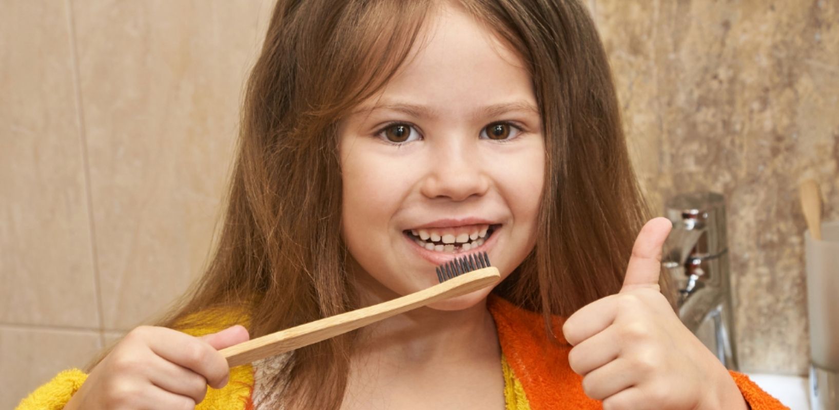 Girl with bamboo toothbrush 1